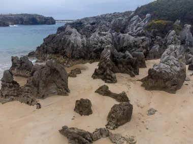 Llanes, Playa de Toro 'daki kayaların hava manzarası, Kuzey İspanya, Asturias' ın yeşil kıyıları, kumlu plajları, uçurumları, gizli mağaraları, yeşil tarlaları, ormanları ve dağları olan.