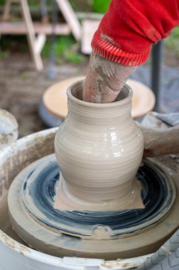 Hollanda 'da atölye çalışması sırasında çömlekçi çarkında çamur tenceresi yapmak