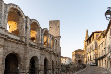 View on old narrow streets and Roman Arena in ancient french town Arles, touristic destination with Roman ruines, Bouches-du-Rhone, France clipart