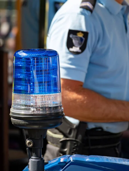 Blue flashing light lamp op police motorbike close-up portrait