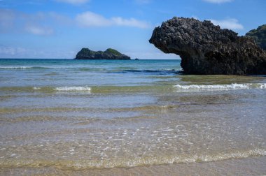 Celorio köyündeki Playa de Palombina Las Camaras 'ın manzarası, Kuzey İspanya, Asturias' ın yeşil kıyıları, kumlu plajları, kayalıkları, gizli mağaraları, yeşil tarlaları, ormanları ve dağları olan.