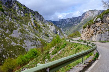 Los Arenas 'tan uzak dağ köyü Sotres' e, Picos de Europa dağlarına, Asturias 'a, İspanya' nın kuzeyine uzanan dar dağ yolu, vadi ve dağların manzarası.