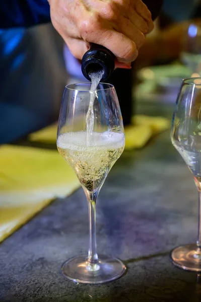 Tasting of sparkling white wine with bubbles champagne on summer weekend festival route of champagne in Celles-sur-Ource, Cote des Bar, Champagne region, France