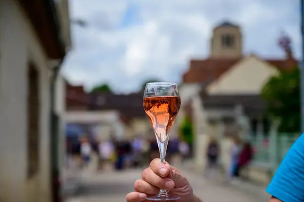 Tasting of sparkling rose wine with bubbles champagne on summer weekend festival route of champagne in Celles-sur-Ource, Cote des Bar, Champagne region, France