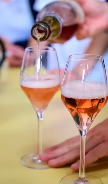 Tasting of sparkling rose wine with bubbles champagne on summer weekend festival route of champagne in Celles-sur-Ource, Cote des Bar, Champagne region, France