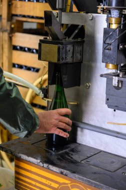 Disgorgement and adding sweet liquor procedure, traditional way of making champagne sparkling wine from chardonnay and pinor noir grapes in Epernay, Champagne, France clipart