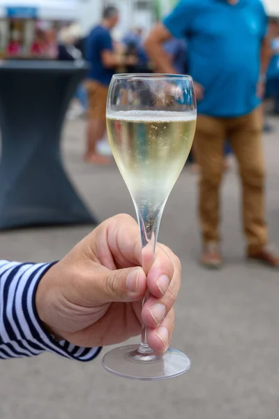 Tasting of sparkling white wine with bubbles champagne on summer weekend festival route of champagne in Cote des Bar, Champagne region, France