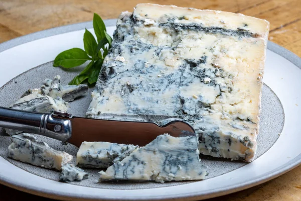Cheese collection, piece of italian blue cheese gorgonzola picante with blue mold from north of Italy close up
