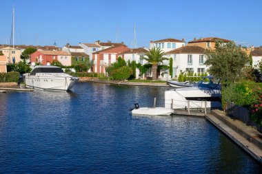 Colorful houses in Port Grimaud, village on Mediterranean sea with yacht harbour, Provence, summer vacation in France.