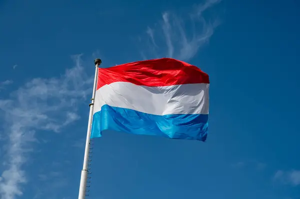 stock image Views of big flag of Luxembourg country and blue sky in Luxembourg or Luxembourg City capital city and one of de facto capitals of European Union in autumn