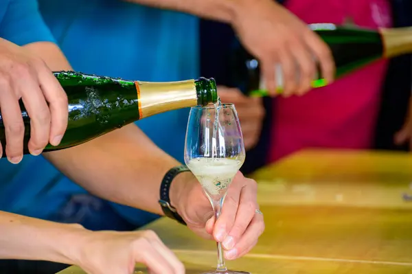 Tasting of sparkling white wine with bubbles champagne on summer weekend festival route of champagne in Cote des Bar, Champagne region, France