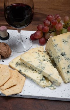 Kırmızı porto ve peynir eşleşmesi, olgunlaşmış mavi Stilton İngiliz peyniri ceviz ve cam yakut porto şarabı ile tatlı olarak servis edilir.