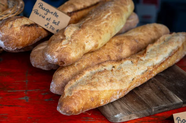 French artisan bakery in Bordeaux, rye and wheat bread and baguettes, English translate - baguette with salt and pepper, France, french food, close up