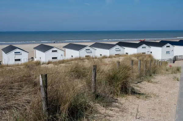 stock image Beach holidays and leisure on sandy beach, waterfront wooden cottages in Katwijk-on-zee, North sea, Netherlands