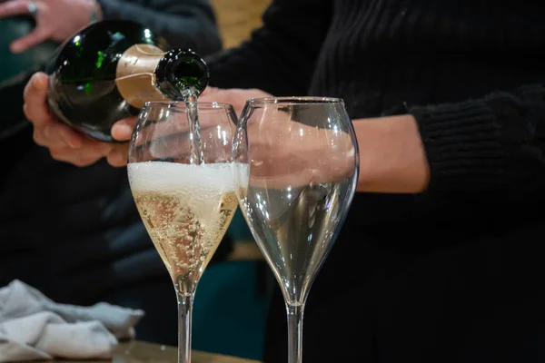 Pouring and tasting of sparkling wine champagne on winter weekend festival in December on Avenue de Champagne, Epernay, Champagne region, France