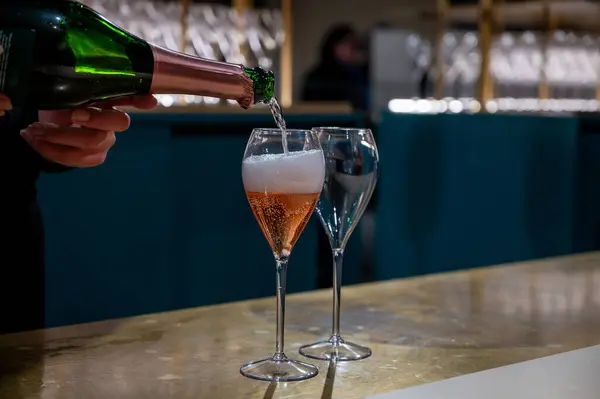 Pouring and tasting of rose sparkling wine champagne on winter weekend festival in December on Avenue de Champagne, Epernay, Champagne region, France