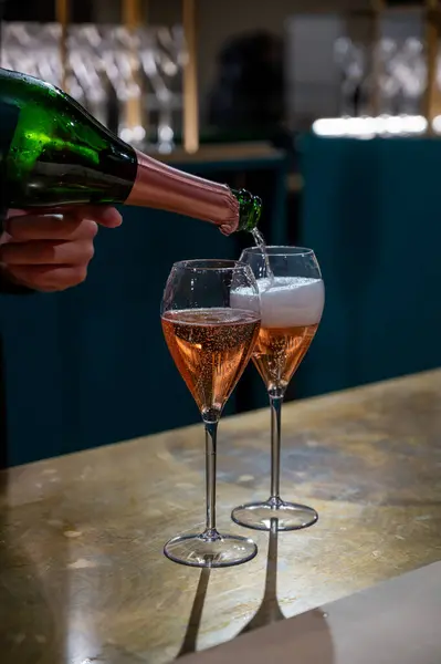 Pouring and tasting of rose sparkling wine champagne on winter weekend festival in December on Avenue de Champagne, Epernay, Champagne region, France