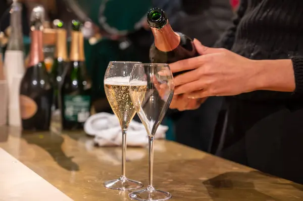 Pouring and tasting of dry sparkling wine champagne on winter weekend festival in December on Avenue de Champagne, Epernay, Champagne region, France