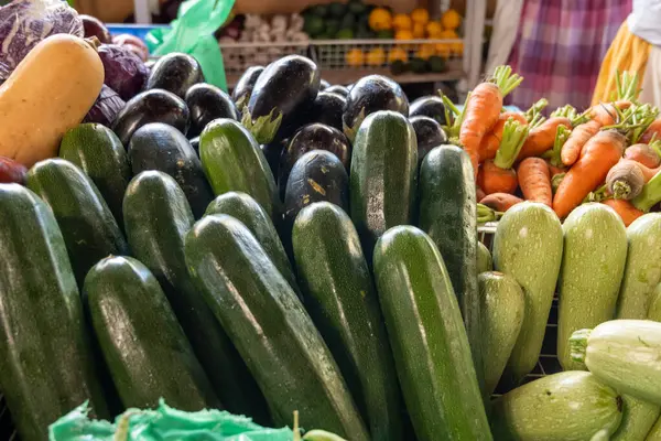 Fresh ripe green zucchini, carrots, tropical fruits and vegetables on farmers market on Fuerteventura, Canary islands, Spain