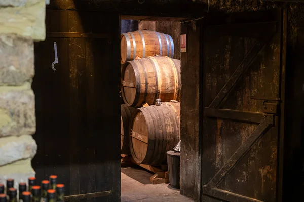 Aging process of cognac spirit in old dark French oak barrels in cellar in distillery house, Cognac white wine region, Charente, Segonzac, Grand Champagne, France