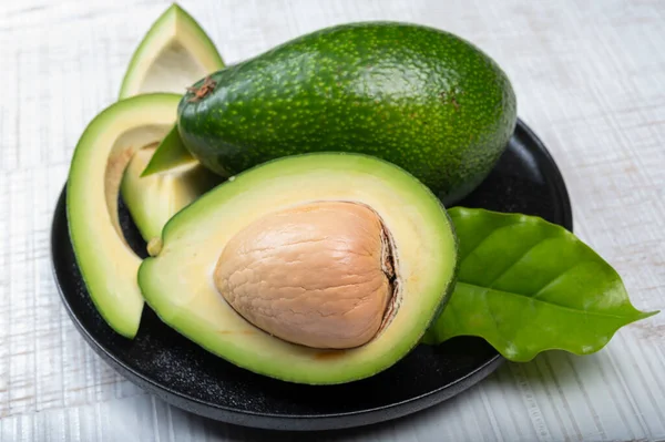 Green ripe avocado fruits from organic avocado plantation - healthy vegan and vegetarian food