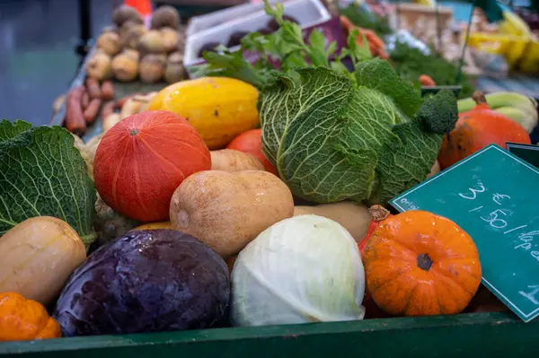 Farmers outdoor market with seasonal winter organic root vegetables, pumpkins, cool, carrots