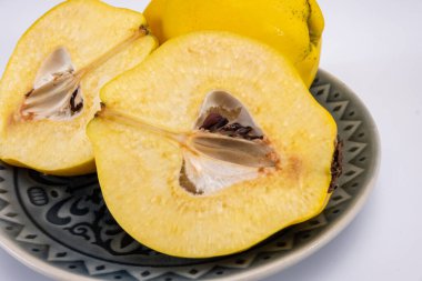 Olgun sarı ayva elmaları grubu beyaz arkaplanı izole ediyor.