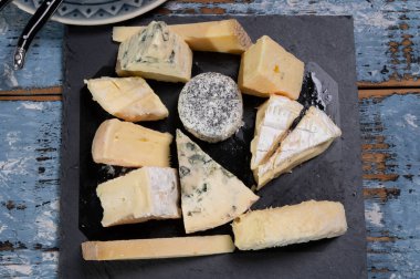 Tasting plate with many small pieces of different French cheeses, variety of cheeses clipart