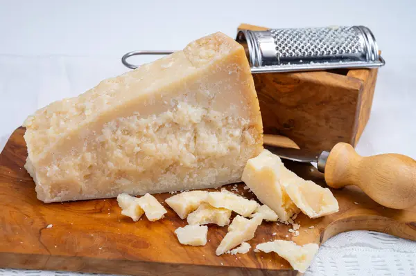Traditional italian food - 24 months aged in caves Italian parmesan hard cheese from Parmigiano-Reggiano, Italy