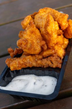 Seafood, outdoor eating of diep-fried cod fish pieces served with remoulade sauce, Dutch street food clipart