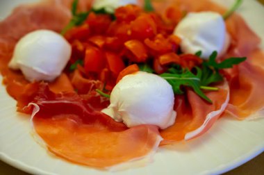 Emilia-Romagna bölgesi mutfağı, İtalyan jambonlu Caprese salatası, prosciutto di Parma, mozzarella ve domates, Parma, İtalya 'da öğle yemeği.