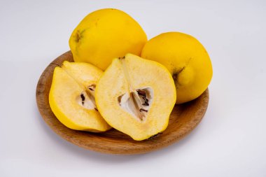 Olgun sarı ayva elmaları grubu beyaz arkaplanı izole ediyor.