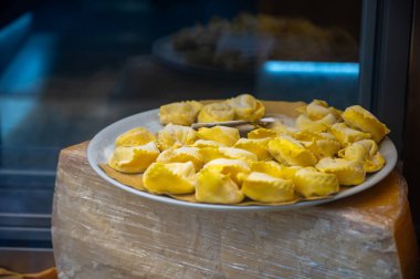 Italian food, fresh homemade stuffed pasta tortelli or ravioli dumplings ready to cook on display, Milan, Lombardy, Italy clipart
