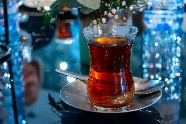 Turkish sweet tea served in traditional glass in restaurant in Istanbul, Turkey, close up