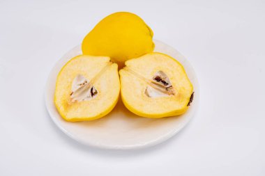 Olgun sarı ayva elmaları grubu beyaz arkaplanı izole ediyor.