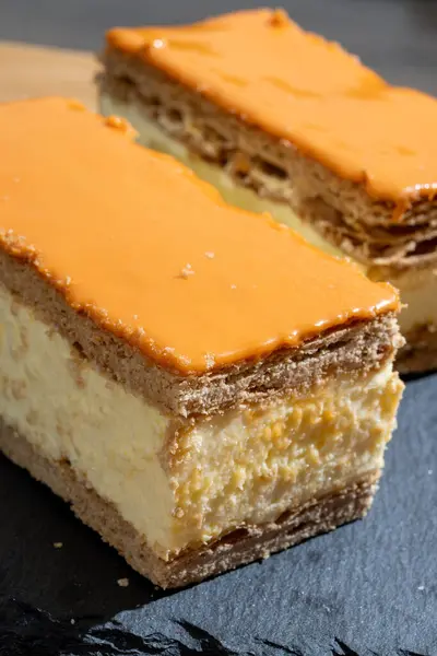 stock image Celebration of the King birthday in Netherlands, tompoes or tompouce, iconic pastry in Netherlands made from puff dough, orange icing, cream close up