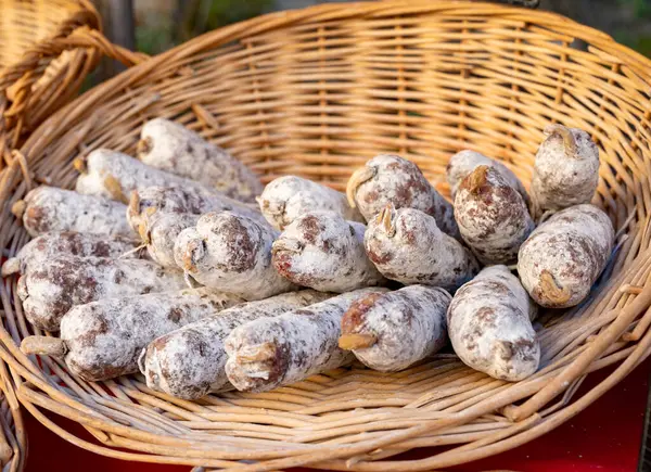 stock image Variety of homemade dried salami sausages in French butchery shop, Dordogne, France, pork meat food background close up