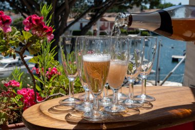 Fransız brut şampanyası şampanya köpüklü lale kadehleri ile Saint-Tropez yakınlarındaki Port Grimaud limanında, Fransız Riviera tatili, Var, Fransa yaz tatili