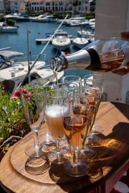 Fransız brut şampanyası şampanya köpüklü lale kadehleri ile Saint-Tropez yakınlarındaki Port Grimaud limanında, Fransız Riviera tatili, Var, Fransa yaz tatili