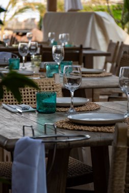 La Rague Limanı 'ndaki restoran, La Napoule Körfezi, Provence, Fransa' nın güneyindeki Cannes yakınlarındaki Fransız Rivierası 'nda öğle yemeği masaları boş servis edildi.