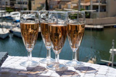 Fransız brut şampanyası şampanya köpüklü lale kadehleri ile Saint-Tropez yakınlarındaki Port Grimaud limanında, Fransız Riviera tatili, Var, Fransa yaz tatili