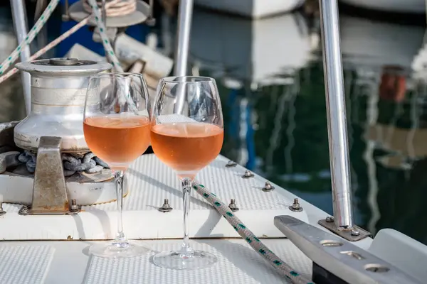 stock image Party with cold rose wine on yacht boat anchored in port la Rague, Gulf of La Napoule, in Provence, two glasses of cold rose wine, French Riviera near Cannes, south of France