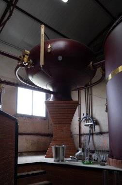 Charentias 'taki konyak ruhlarının çifte damıtma işlemi. Bakır alambik hala eski bir içki imalathanesinde, Charente, Segonzac, Grand Champagne, Fransa