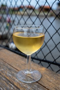 Tasting of Bordeaux white wine, France. Glasses of white sweet French wine served in outdoor restaurant, oysters farm in Gujan-Mestras, Arcachon bay clipart