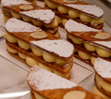 Portion of french mille-feuille cake, vanilla or custard slice, Napoleon puff pastry layered with pastry cream in bakery clipart