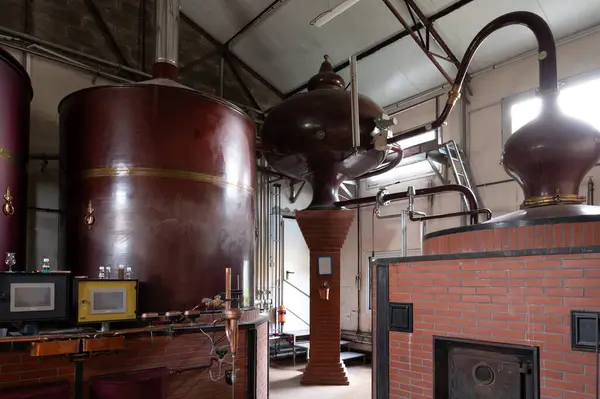 stock image Double distillation process of cognac spirits in Charentias copper alambic still pots and boilers in old distillery in Cognac white wine region, Charente, Segonzac, Grand Champagne, France