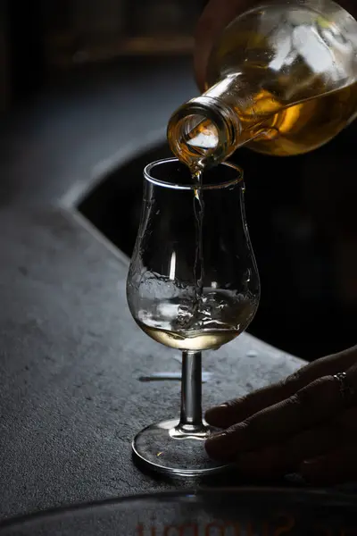 stock image Tasting of cognac spirit aged in old dark French oak barrels in cellar in distillery house, Cognac white wine region, Charente, Segonzac, Grand Champagne, France