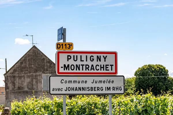 stock image Road sign Puligny-Montrachet village, wine of Burgundy France. High quality white dry wine making from Chardonnay grapes on grand cru classe vineyards and clos