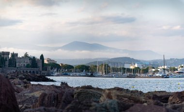 Coastline with stones, bays, castle in Mandelieu-la-napoule near Cannes, French Riviera, France in summer clipart