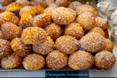 Many Chouquettes or petits choux are small pieces French patisserie consisting of small spheres of choux pastry, sugared and baked, Bordeaux, France clipart